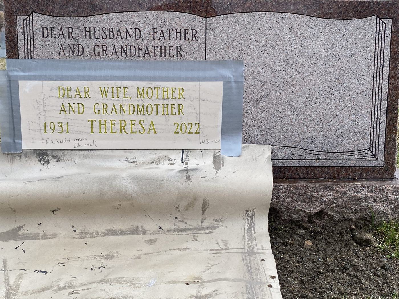 Inscription stencil applied to headstone - Monument Inscriptions Lettering stencil applied to an existing granite headstone at the cemetery before sandblasting