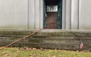 Mausoleum on-site engraving - Monument Inscriptions Private granite mausoleum with equipment set up for on-site crypt engraving