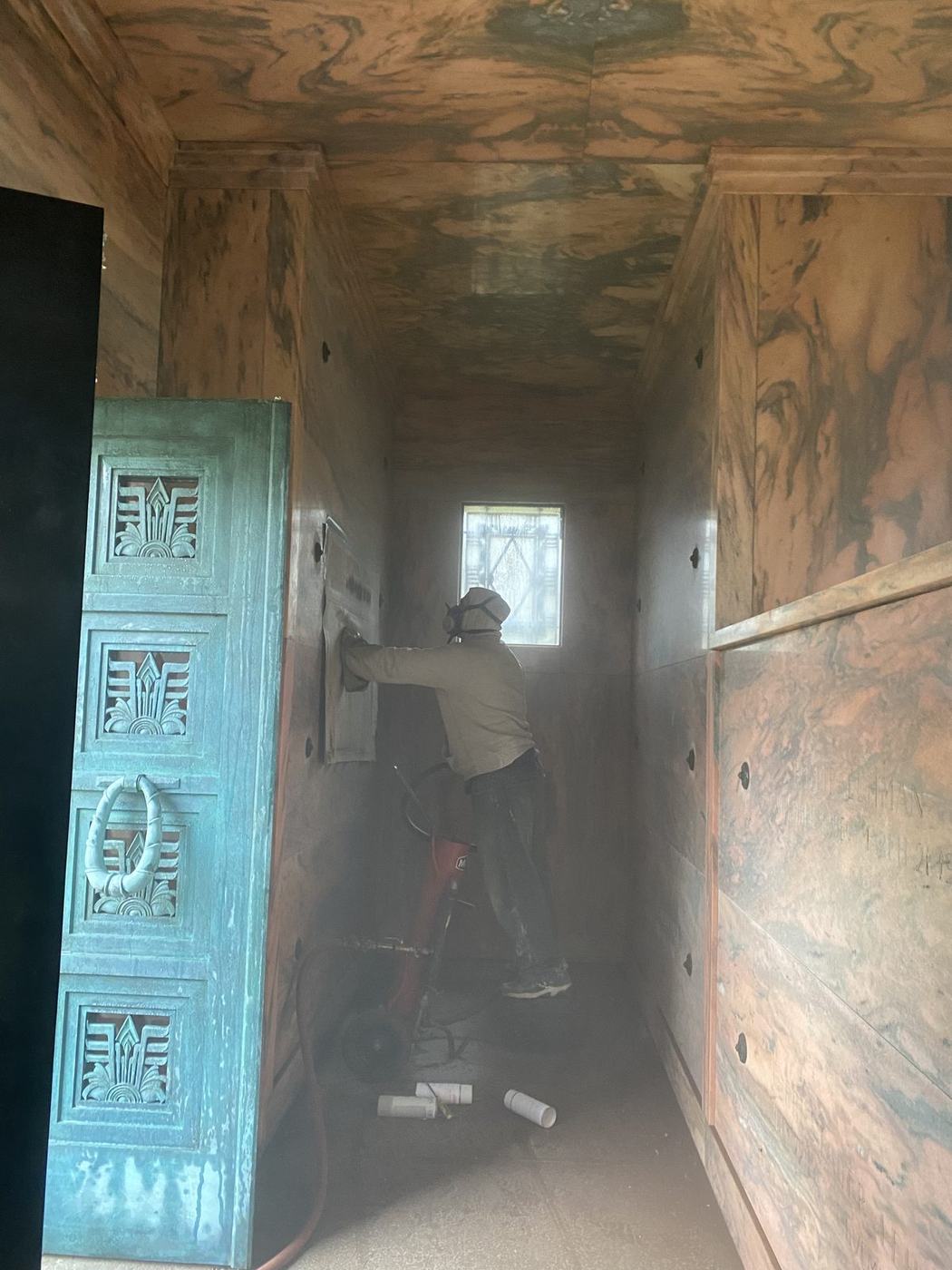 On-site sandblast engraving in mausoleum - Monument Inscriptions Engraver sandblasting an inscription onto a crypt front inside a mausoleum